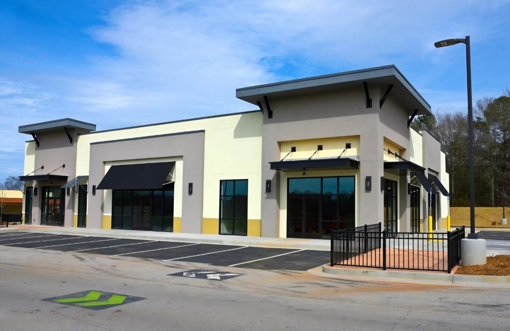 Commercial storefront with modern exterior, crisp trim lines, and smooth stucco finish by an exterior painter in Grants Pass, OR.