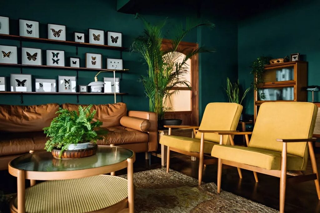 Living room with deep green painted walls and a smooth finish by a painter in Medford, OR