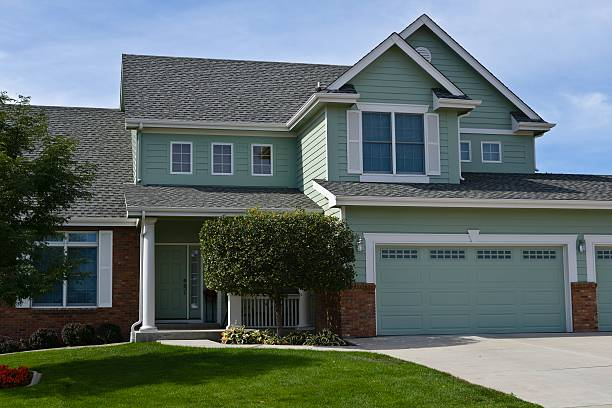 Light blue home exterior with white trim and durable exterior coatings by an exterior painter in Rogue River, OR