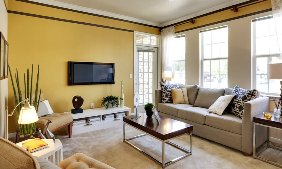 Warm-toned living room with powder yellow accent wall painted by a house painter in Grants Pass, OR