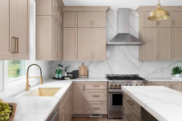 Neutral taupe kitchen cabinets with white trim and smooth finishes by a house painter in Rogue River, OR.