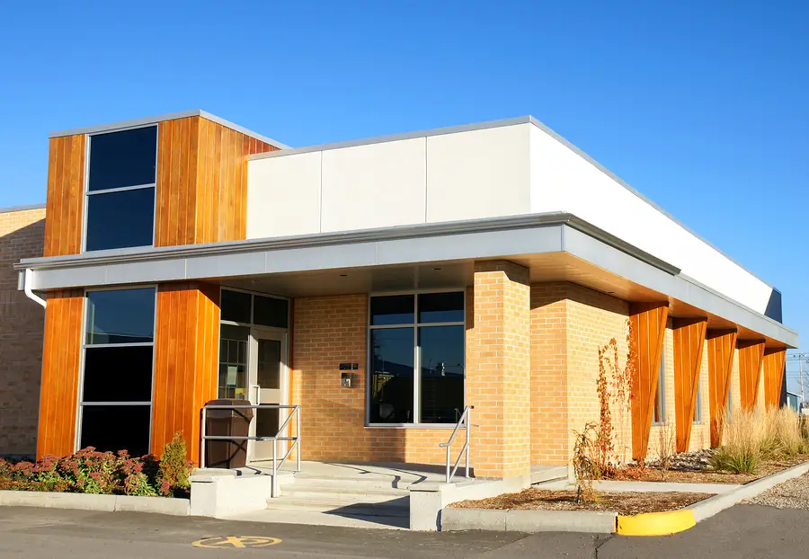 Commercial building exterior with fresh paint, brick walls, and wood accents by a painting company in Cave Junction, OR